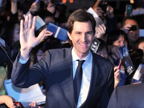 US director Joseph Kosinski waves on the red carpet during the Taiwan premier of their latest film 'Oblivion' in Taipei on April 6, 2013. AFP PHOTO / Mandy CHENG (Photo credit should read Mandy Cheng/AFP/Getty Images)