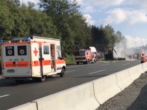 In this photo taken from a video smoke rises from a coach after a crash on the motorway AP near Muenchberg, southeastern Germany. Police say that people might have been killed in the crash. (News5/ via AP)