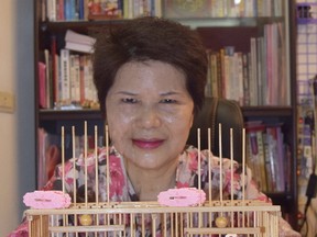 Fortune teller Miss Chen uses birds to help tell peoples’ fortunes in a tiny cubicle near Taipei's Longshan Temple. (STEVE MACNAULL PHOTO)