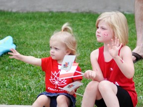 An hour-long parade last Friday, June 30 kicked off Canada’s Sesquicentennial celebration in West Perth as hundreds of people lined the parade route. Watching and waving intently were cousins Emma Arts (left), 1 ½ and Miranda Scherbarth, 6. ANDY BADER/MITCHELL ADVOCATE