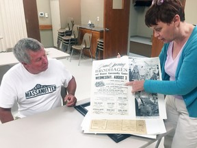 Mary Rose Louwagie-Kroonen (right), president of the Brodhagen Chamber of Commerce, looks over some memorabilia with longtime member and former president Bob Jarmuth prior to the organization’s 60th anniversary celebration. ANDY BADER/MITCHELL ADVOCATE