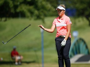 Brooke Henderson tosses her club after missing a birdie on the 16th green during the final round of the Women's PGA Championship at Olympia Fields Country Club in Olympia Fields, Ill., on Sunday, July 2, 2017. (Charles Rex Arbogast/AP Photo)