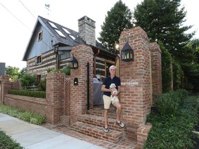 In a Tuesday, June 27, 2017 photo, Jude Plum with his dog Miss "P" pose for a photo at his 300-year-old log home in Bryn Mawr, Pa. The home is one of Lower Merion Township's two oldest remaining houses. (Steven M. Falk/The Philadelphia Inquirer via AP)