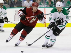 Dallas Stars right winger Ales Hemsky and Arizona Coyotes centre Max Domi skate for the puck during the first period of an NHL game on March 31, 2016. (THE CANADIAN PRESS)