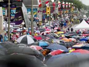 Thousands of people wait make their way through a long security check lineup on Wellington St. during Canada Day celebrations in downtown Ottawa Saturday, July 1, 2017. (Darren Brown, Postmedia)