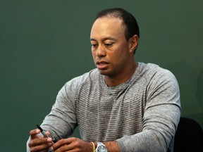 In this March 20, 2017, file photo, golfer Tiger Woods prepares to sign copies of his new book at a book signing in New York. Woods is receiving help to manage his medications. (AP Photo/Seth Wenig, File)