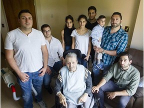 Georges Karam, centre, is photographed with many of his grandchildren in his room at the Garry J Armstrong home in Ottawa. Darren Brown, Postmedia.