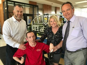 Legionnaires super-fan Robert Christopher (in red) has donated time, energy and money to make Sarnia Arena a more accessible venue through the Sarnia Arena Revitalization Project. Christopher gives a donation to parks and recreation director Rob Harwood, and is flanked by councilors Brian White and Cindy Sholten. 
Handout/Sarnia This Week