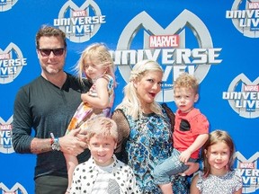Actors Dean McDermott and Tori Spelling and their children arrive at the Super Heroes and Hollywood Stars Unite on the Red Carpet for Action-Packed Celebrity Family Premiere of the All-New Arena Spectacular Marvel Universe LIVE!, in Los Angeles, California, May 2, 2015. (VALERIE MACON/AFP/Getty Images)