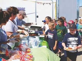 Hamburgers, hot dogs, homemade French fries and ice cream were served to the community recently during Circle Day at Servus Credit Union. Several groups of school children also arrived for lunch with their teachers. The event was a way of giving back to the community.