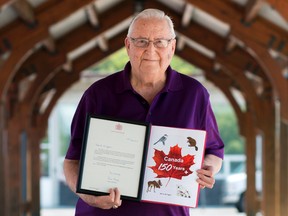 Taylor Bertelink/For The Intelligencer
Milton McTaggart holds a framed copy of the letter of recognition he received from Her Majesty The Queen, at the Downtown Belleville Farmers' Market where he sells his books. "I am just so thrilled," said McTaggart after receiving the letter.