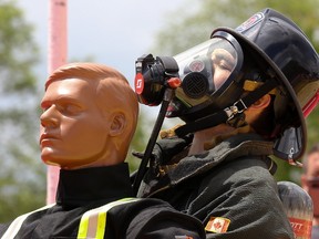 Tim Miller Photos/The Intelligencer
A firefighter breathes heavily as he drags a 165-lb. rescue dummy across the Firefit competition in Centennial Park.