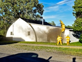 Fire crews battle a structural fire in the Village of Cowley on June 27.