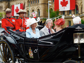 Camilla Duchess of Cornwall, Prince Charles, Sharon Johnston and Governor General David Johnston ride in a carriage during Canada 150 celebrations in Ottawa on Saturday, July 1, 2017. (THE CANADIAN PRESS/ Sean Kilpatrick)
