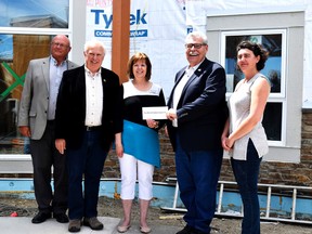 L-R: Coun. Doug Thornton, Mayor Don Anderberg, Millie Loeffler, Reeve Brian Hammond and Sahra Nodge gathered in front of the new Crestview Lodge building on June 28.