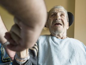 Georges Karam chats with his grandson, Daniel Nassrallah in his room at the Garry J Armstrong home in Ottawa Monday July 3, 2017. Karam was assaulted by an orderly and the incident was caught on camera the family had previously installed in his room. (Darren Brown, Postmedia)