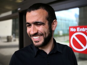 Omar Khadr smiles outside the Edmonton Law Courts Buildings on Thursday afternoon on May 7, 2015. (Tom Braid/Edmonton Sun)