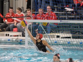 Goalkeeper Jessica Gaudreault of Ottawa rockets out of the water to make a save, but Canada lost its quarterfinal by one goal and missed qualifying for the 2016 Summer Olympic Games. (Diane Bekhazi/Water Polo Canada)