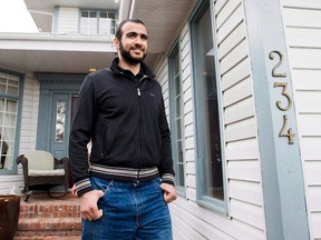 Omar Khadr walks out the front door of his lawyer Dennis Edney's home to speak the media in Edmonton, Alberta on Thursday, May 7, 2015. The lawyer for the widow of an American soldier killed in Afghanistan said Tuesday they have filed an application so that any money paid by the Canadian government to a former Guantanamo Bay prisoner convicted of killing him will go toward the widow and another U.S. soldier injured. THE CANADIAN PRESS/Nathan Denette