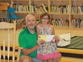 New England Arbors' John Hollingsworth receives a thank-you card from Grace Ellis, a Grade 1 student at Rosedale Public School in Sarnia. Rosesdale first-graders made over 100 thank-you cards for organizations sponsoring local children's author Jen Dafoe's new book, Chico's First Visit to the Hospital.
CARL HNATYSHYN/SARNIA THIS WEEK