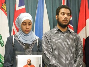 Afnan Jaballah, 13, holds a photo of her father, Mahmoud Jaballah, as her brother Ahmad Jaballah looks on during a press conference on Parliament Hill in Ottawa, on Friday, Feb. 2, 2007. Strict release conditions need to continue for an Egyptian man the federal government has long branded as a potentially dangerous terrorist, a Federal Court judge has ruled. THE CANADIAN PRESS/Patrick Doyle