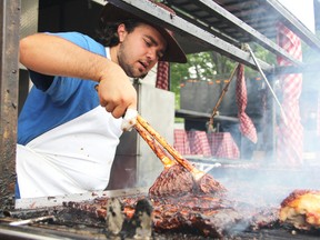 Victor Anast of Kentucky Smokehouse was among the various ribbers at the 2012 edition of the Sarnia Kinsmen Ribfest,  held at Centennial Park. The Kinsmen Ribfest will be returning to Centennial Park this weekend – the first time since 2012 – beginning on Friday and continuing through to Sunday. (File photo/Sarnia Observer)