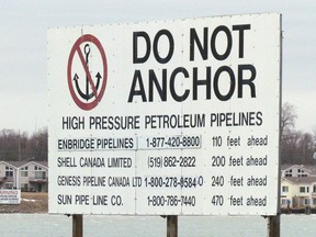 A sign  near Corunna, south of Sarnia, Ont., marks where several pipelines cross the St. Clair River between Michigan to Ontario. St. Clair Township Mayor Steve Arnold is seeking information from Enbridge about its Line 5 pipeline that runs through Michigan to Sarnia. Government officials and environmental groups in Michigan are questioning the safety of a section of the pipeline that crosses the Straits of Mackinac. (File photo/Sarnia Observer/Postmedia Network)