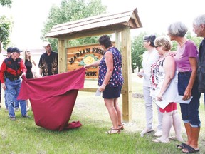 The green space on the corner of Anne Street and Fourth Street South was dedicated June 24 to honour the memory of the late Marian Fisher, who died in 2014 at the age of 86. Here, family members unveil the plaque in Fisher’s name. Jasmine O’Halloran Vulcan Advocate