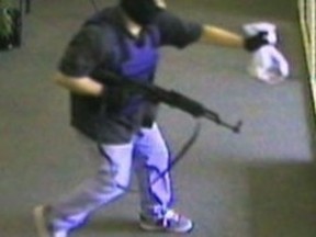 This undated image from surveillance video released by the FBI shows the suspect known as the AK-47 Bandit. Authorities say a Montana man accused of shooting at a Kansas state trooper is a bank robber dubbed "the AK-47 bandit" by the FBI. (FBI via AP)