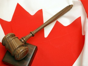 In this stock photo a wooden gavel rests on a block atop a Canadian flag. (Getty Images)