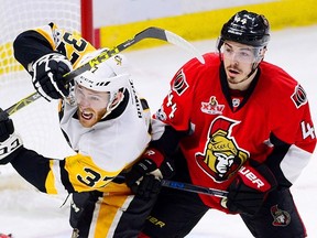Pittsburgh Penguins right winger Carter Rowney is checked by Ottawa Senators centre Jean-Gabriel Pageau during Game 4 of the Eastern Conference final in Ottawa on May 19, 2017. (THE CANADIAN PRESS/Sean Kilpatrick)