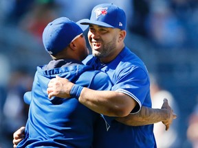 Toronto Blue Jays catcher Miguel Montero, recently traded to the Blue Jays after he was released from the Chicago Cubs, celebrates with a teammate after the Jays defeated the New York Yankees on July 5, 2017. (AP Photo/Kathy Willens)