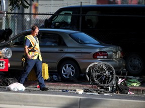 A wheelchair, shoes and other items lay in the street as officials work at the scene of an accident in Salt Lake City on Tuesday, July 4, 2017. (Spenser Heaps/The Deseret News via AP)