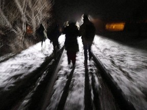 Early Sunday morning, February 26, 2017, eight migrants from Somalia cross into Canada illegally from the United States by walking down this train track into the town of Emerson, Man., where they will seek asylum at Canada Border Services Agency. (John Woods/The Canadian Press)