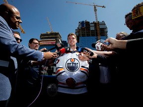 Connor McDavid speaks to the media at a Ice District construction site, following a press conference where it was announced that he has signed an eight-year contract worth $12.5 million a year with the Edmonton Oilers, in Edmonton Wednesday July 5, 2017.