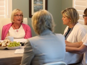 Carol Saxby, left, talks to London West MPP Peggy Sattler,  NDP Leader Andrea Horwath and London Fanshawe MPP Teresa Armstrong Wednesday about long-term care. Saxby?s mother has been in a home for 7 1/2 years and Saxby has noticed a decline in care as staff workload increases. (MIKE HENSEN, The London Free Press)