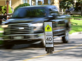 Flexible road signs on Viscount Road remind motorists to slow down in a London school zone. A London study last year found the signs actually work. (MIKE HENSEN, The London Free Press)