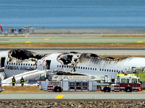 An Asiana Airlines Boeing 777 is seen on the runway at San Francisco International Airport after crash landing on July 6, 2013. (Getty Images)