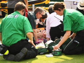 Bethanie Mattek-Sands of the U.S. receives treatment from the medical team and later retires from the second round match against Sorana Cirstea of Romania at Wimbledon in London, England, on Thursday, July 6, 2017. (David Ramos/Getty Images)