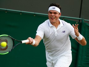 Canada's Milos Raonic returns the ball to Russia's Mikhail Youzhny during their Men's Singles Match on Day 4 at the Wimbledon Tennis Championships in London on July 6, 2017. (AP Photo/Alastair Grant)