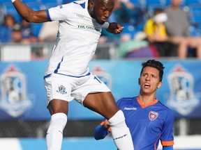 FC Edmonton midfielder Sainey Nyassi (14) heads the ball as Miami FC Roberto Baggio Kcira (14) defends during first half action at Clarke Park. June 10, 2017.