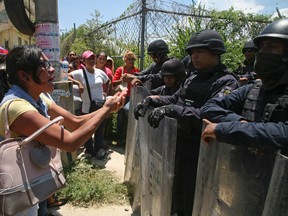 Relatives of inmates confront state police securing the area around the state prison in Acapulco, Mexico, Thursday, July 6, 2017. (AP Photo/Bernandino Hernandez)