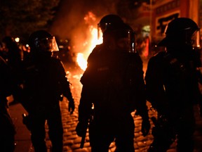 Riot police gather after protesters erected burning barricades during a protest march on July 6, 2017 in Hamburg, Germany. (GETTY IMAGES)