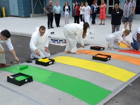 Mauricio Osorio, left, Morganna Sampson, Rich Callacott, Carlie Forsythe and Jahmoyia Smith, were among Fanshawe College students and staff who gathered Thursday to paint a rainbow crosswalk in support of Pride London. The school has a number of Pride Week activities planned, starting with the raising of the Pride flag on July 20. The school hopes the crosswalk will be a year-round sign of Fanshawe?s inclusive environment. (MORRIS LAMONT, The London Free Press)