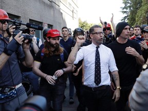 Gavin McInnes is surrounded by supporters after speaking at a rally Thursday, April 27, 2017, in Berkeley, Calif. (THE CANADIAN PRESS/AP-Marcio Jose Sanchez)