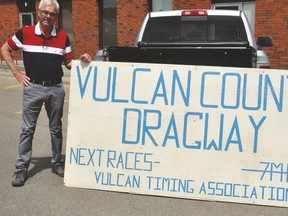Eldon Maronda, who was a member of the Vulcan Timing Association, stands by a sign that used to be posted to inform the public of drag races at the Kirkcaldy aerodrome. Stephen Tipper Vulcan Advocate