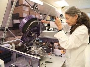 Dr. Leslie Sutherland, a scientist at Health Sciences North Research Institute, works with a smoke machine in the HSNRI lab last month. (John Lappa/Sudbury Star)