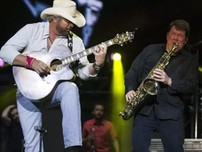 Toby Keith, left, performs during the opening night of the 2017 Ottawa Bluesfest Thursday, July 6, 2017.