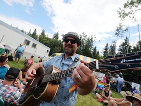Rob Wrigley of Double The Trouble plays his guitar while waiting for the gates to open at the 44th annual Winnipeg Folk Festival on Thursday, July 6, 2017 at Birds Hill Provincial Park located just outside Winnipeg, Man. (Brook Jones, Selkirk Journal, Postmedia Network)