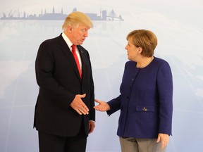 U.S. President Donald Trump, left, and German Chancellor Angela Merkel pose for a photograph prior to a bilateral meeting on the eve of the G-20 summit in Hamburg, northern Germany, Thursday, July 6, 2017. The leaders of the group of 20 meet July 7 and 8. (AP Photo/Matthias Schrader, pool)